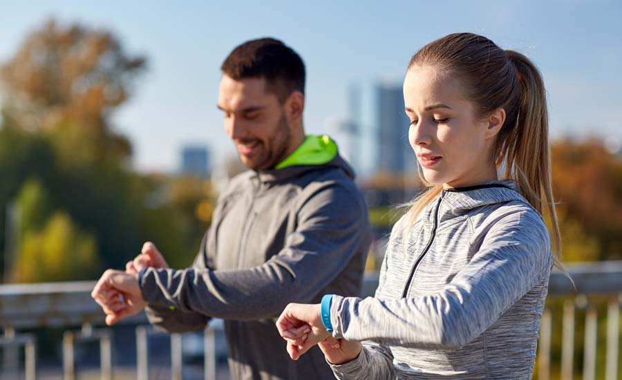 Runners checking their devices for steps and calories
